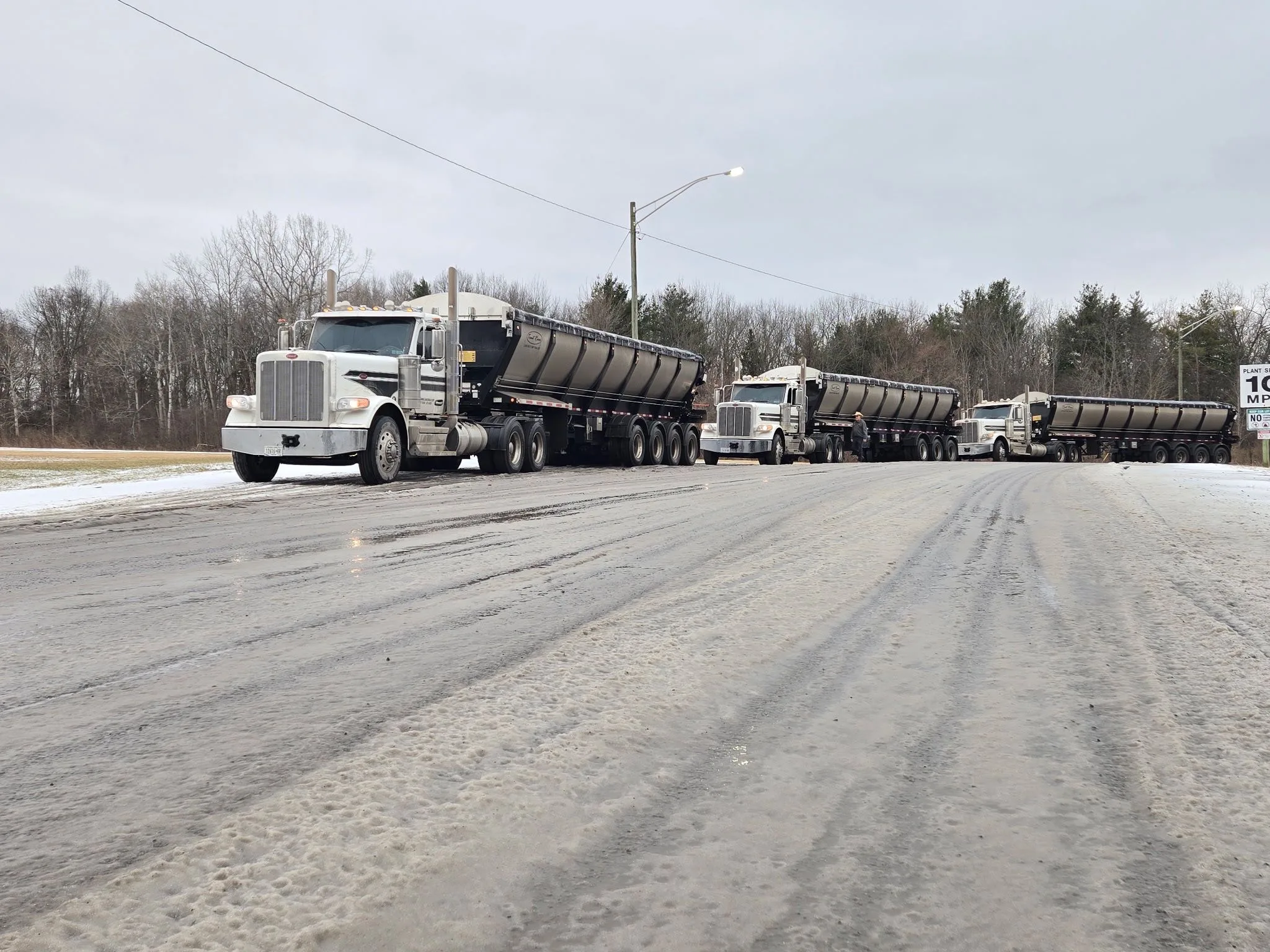 Bulk salt trailers lined up on a winter road