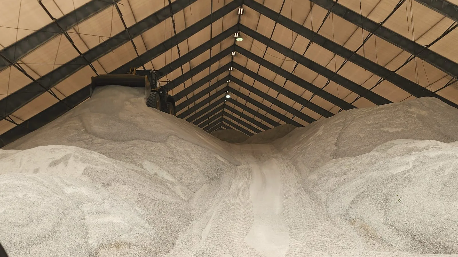Rock salt stockpiled inside a covered storage building