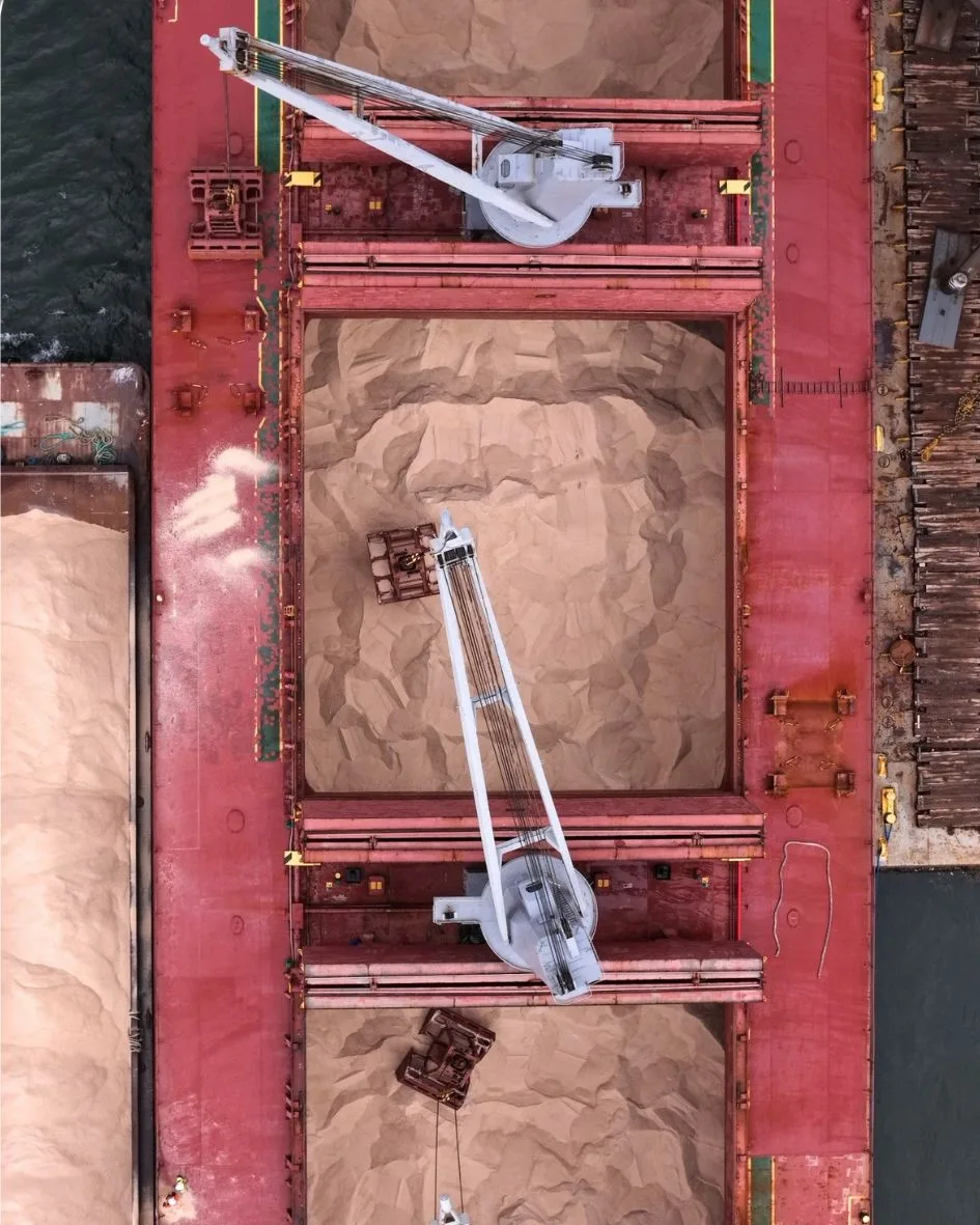 Looking straight down on grabs working the open holds of rock salt